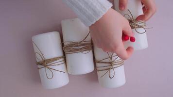 Step by step instruction of making handmade Christmas advent four weeks candle calendar. Female hands creating craft homemade decor. New year celebration. Winter holidays. Do it yourself video