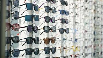 Stand with glasses in the store of optics video