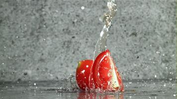 Fresh tomatoes with a splash of water. Filmed on a high-speed camera at 1000 fps. High quality FullHD footage video