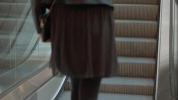 Modern escalator with glass railings leading upwards in public space. Infrastructure for urban mobility video