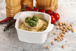 Tasty hummus with green olives photo