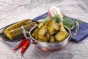 Sliced marinated cucumbers in the bowl photo