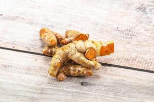 Fresh young Tumeric root heap photo