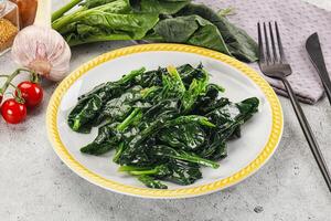 Coocked green spinach with oil photo