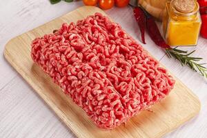 Raw minced beef meat over board photo