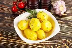 Boiled potato with oil and dill photo