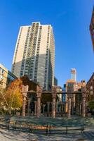 New York , USA - November 18, 2009 historical place with columns against the backdrop of a skyscraper in Manhattan, New York, USA photo