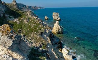 View of the steep banks and rocks in the water in the Dzhangul tract, western Crimea photo
