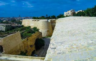 GOZO, MALTA - SEPTEMBER 14, 2012 View from the Valletta City Gate bridge to Valletta Ditch and St. John's Bastion in Valletta, Malta photo