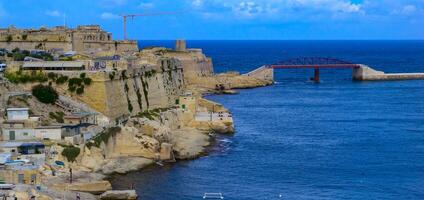VALLETTA, MALTA - SEPTEMBER 14, 2012 view of the fort and the iron bridge at the entrance to the bay in Valletta on the island of Malta photo