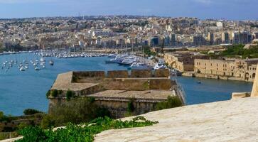 VALLETTA, MALTA - SEPTEMBER 14, 2012 View from the Valletta City Gate bridge to Valletta Ditch and St. John's Bastion in Valletta, Malta photo