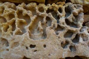 Weathering, erosion and destruction of limestone bricks of ancient structures on the island of Gozo, Malta photo