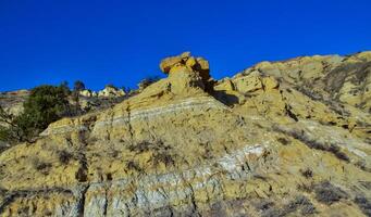 Geological stony-clay landscape, mountains and rocks in the evening at sunset. North Dakota photo