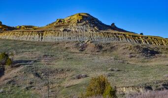 Geological stony-clay landscape, mountains and rocks in the evening at sunset. North Dakota photo