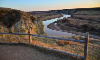 View of the winding river from the mountain in the evening at sunset. North Dakota photo