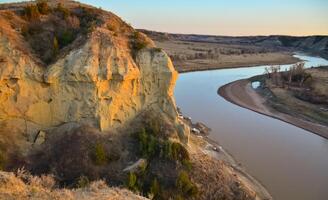 View of the winding river from the mountain in the evening at sunset. North Dakota photo