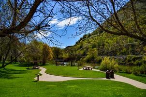 Table and benches in a recreation area near a small river in Utah, US photo
