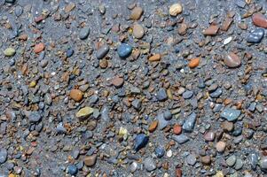 Kara-Dag, a round sea-rolled pebble from a volcanic rock on a pebble beach, Crimea photo