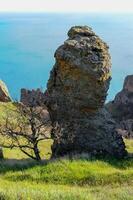 Mountain landscape, vertical weathered volcanic rocks on the slopes of the mountains photo