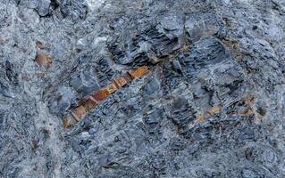 A layer of the mineral opal in the volcanic rock of the mountain of the ancient volcano Karadag photo