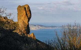 Mountain landscape, vertical weathered volcanic rocks on the slopes of the mountains photo