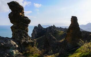 Mountain landscape, vertical weathered volcanic rocks on the slopes of the mountains photo
