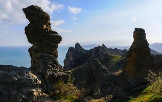 Mountain landscape, vertical weathered volcanic rocks on the slopes of the mountains photo
