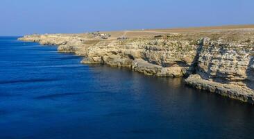 Steep steep coast of limestone rocks in the western Crimea, Tarkhankut Peninsula photo