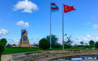TRABZON, Turkiye - OCTOBER 22, 2014 - View of monument and Turkish flag in Trabzon, Turkiye photo