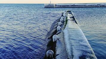 View of the icy pier on the beach in Arcadia in winter, Odessa, Ukraine photo