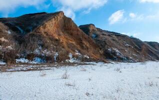 Glazed cliffs in the snow in winter on the banks of the Tiligulsky estuary, Odessa region photo