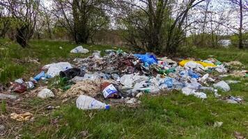 Plastic, polyethylene and glass trash in the wild, environmental pollution photo
