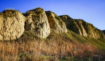 Clay eroded rocks, steep coastal slope around the lake photo