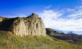 Clay eroded rocks, steep coastal slope around the lake photo