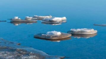 Blocks of ice near the shore in the lower reaches of the Tiligul estuary on a sunny day, Ukraine photo