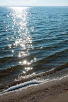 Sun glare on the water near the sandy spit in Tiligul estuary, Ukraine photo