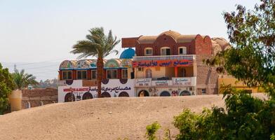 EGYPT, LUXOR - MARCH 01, 2019 advertising signs on an Egyptian house with shops and workshops, Egypt photo
