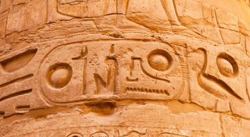 EGYPT, LUXOR - MARCH 01, 2019 ancient Egyptian hieroglyphs, drawings and inscriptions on the walls and columns in the temple of Karnak in Luxor photo