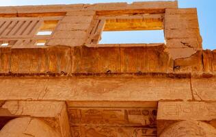 EGYPT, LUXOR - MARCH 01, 2019 ancient temple columns with hieroglyphs, drawings and inscriptions at Karnak in Luxor, Egypt photo