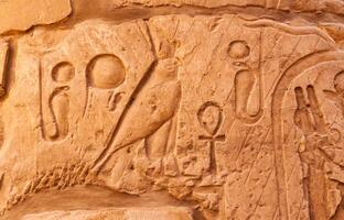 EGYPT, LUXOR - MARCH 01, 2019 ancient Egyptian hieroglyphs, drawings and inscriptions on the walls and columns in the temple of Karnak in Luxor photo
