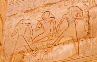 EGYPT, LUXOR - MARCH 01, 2019 ancient Egyptian hieroglyphs, drawings and inscriptions on the walls and columns in the temple of Karnak in Luxor photo