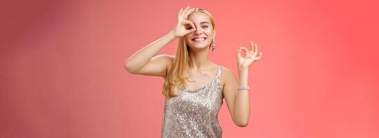 Charming funny tender feminine blond girlfriend dancing having fun enjoying perfect party smiling broadly show okay ok excellent gesture like new dress grinning satisfactory, red background photo