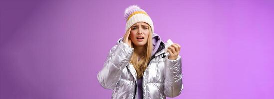 Ill upset sobbing cute blond girl feel unwell hold napkin tissue touching head temple frowning grimacing painful migraine got sick during winter vacation walking outdoor headache temperature photo