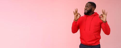 Guy assuring customer like result. Charismatic outgoing african american bearded young guy persuading you everything cool under control show okay ok no problem gesture, smiling assuring all good photo