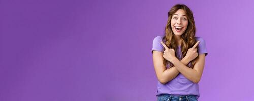 Lively surprised charismatic curly girl fascinated look admiration joy picking between awesome opportunities amazed excellent choices pointing sideways left right make decision purple background photo