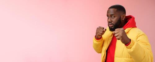 Better not mess me. Portrait serious-looking strong african-american boyfriend stand for girlfriend raising fists ready defend boxing pose wanna punch offender, standing pink background photo