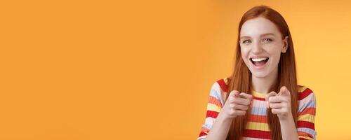 Enthusiastic carefree friendly redhead girl pointing finger-pistols camera smiling joyfully congratulating friend awesome choice cheeky greeting hinting girlfriend caught good opportunity photo