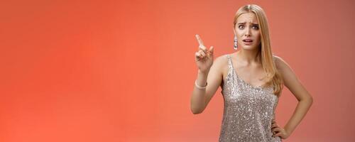 How could you. Disappointed let down upset complaining young woman demanding respect raise index finger scolding teaching lesson give instructions standing bothered displeased, red background photo