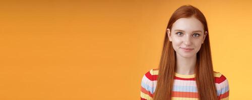 Attractive self-assured redhead girl encouraging herself look mirror confident prepare interview speech standing orange background smirking intrigued listening talking casually photo