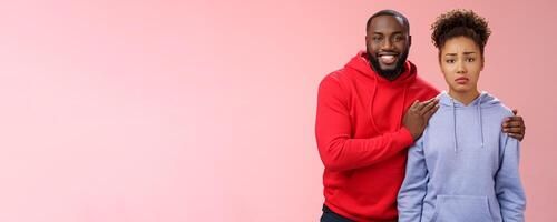 Girl unwilling participate event feel nervous insecure boyfriend encouraging hugging boost confidense assuring everything alright smiling self-assured promise everything be okay, pink background photo
